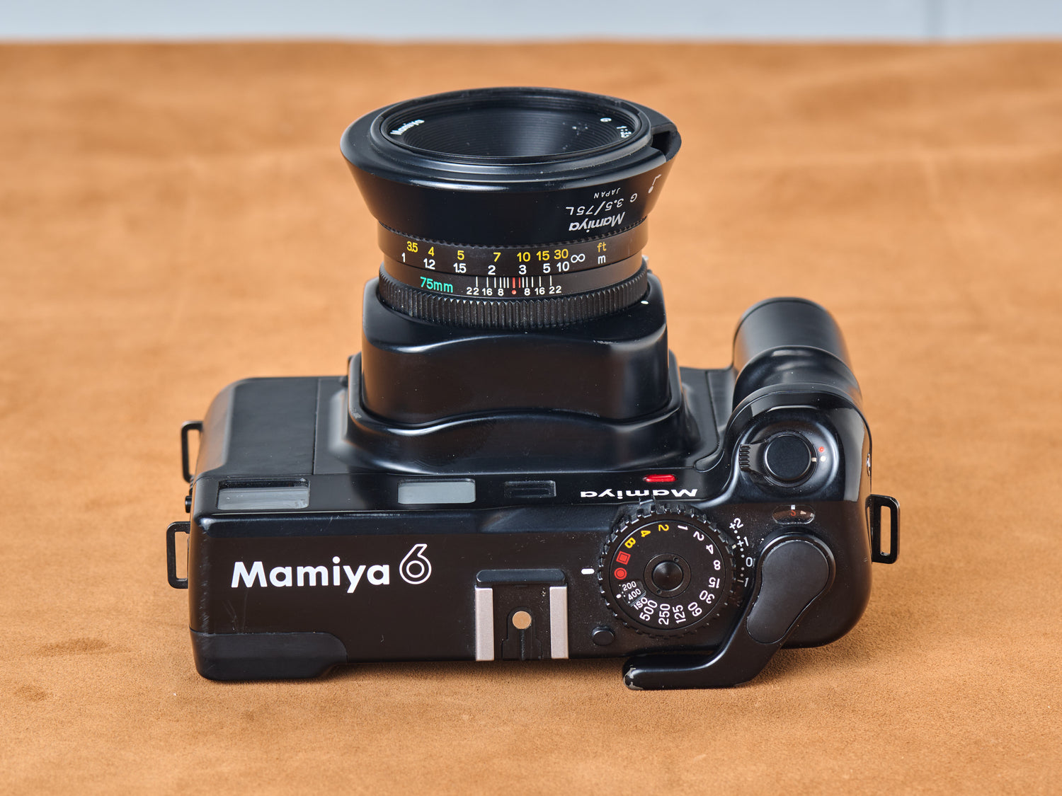Mamiya 6 medium format rangefinder film camera with 75mm lens. Top view.