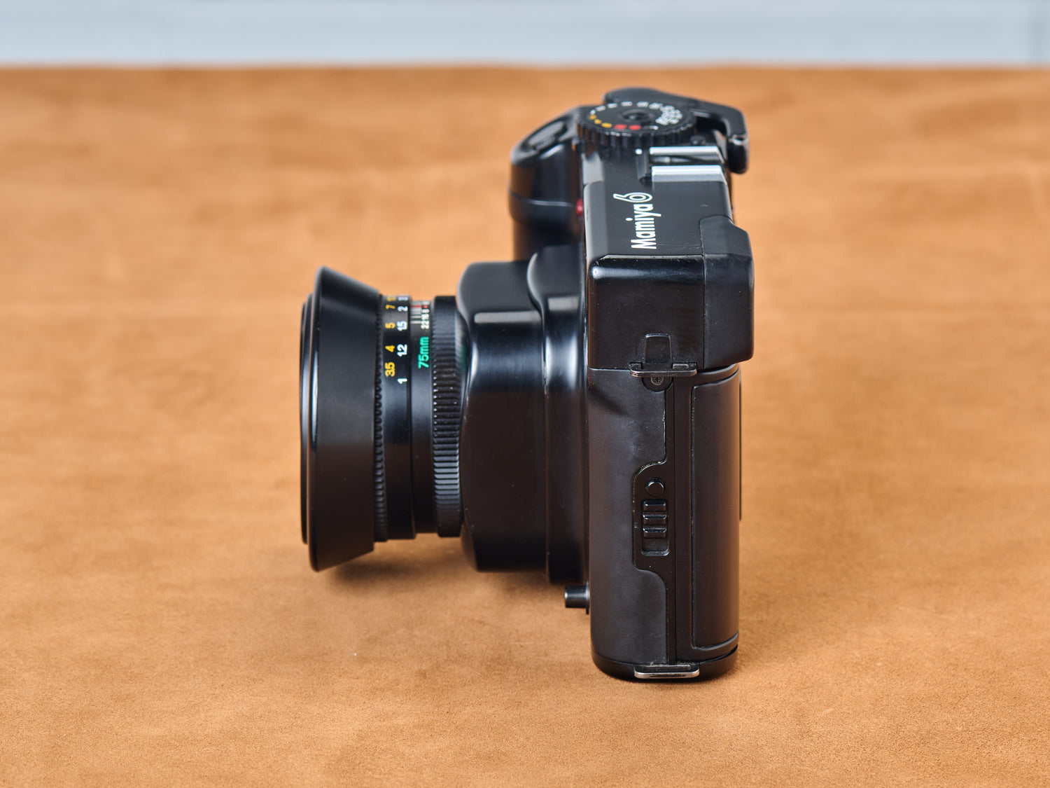 Mamiya 6 rangefinder film camera with 75mm lens. Side view.