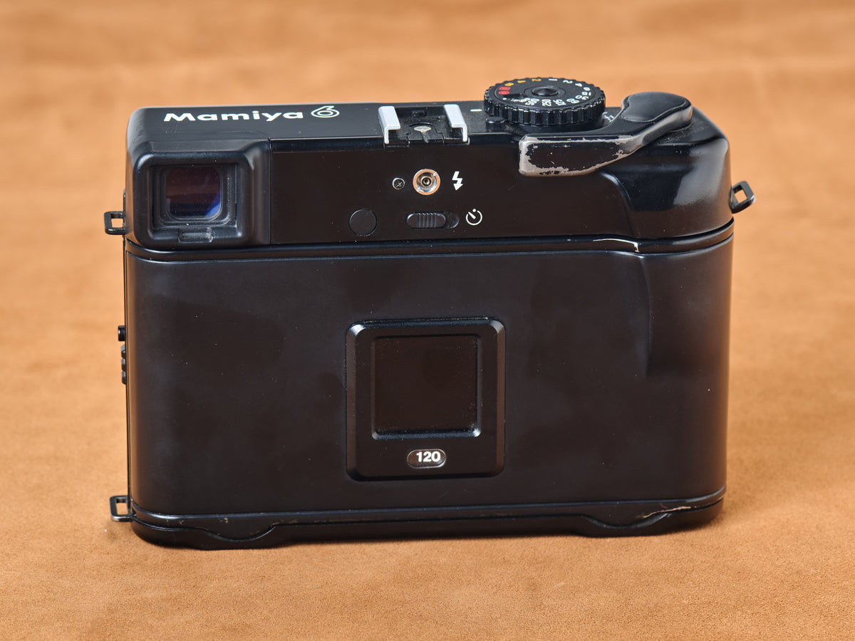 Mamiya 6 medium format rangefinder film camera with 75mm lens. Back view,