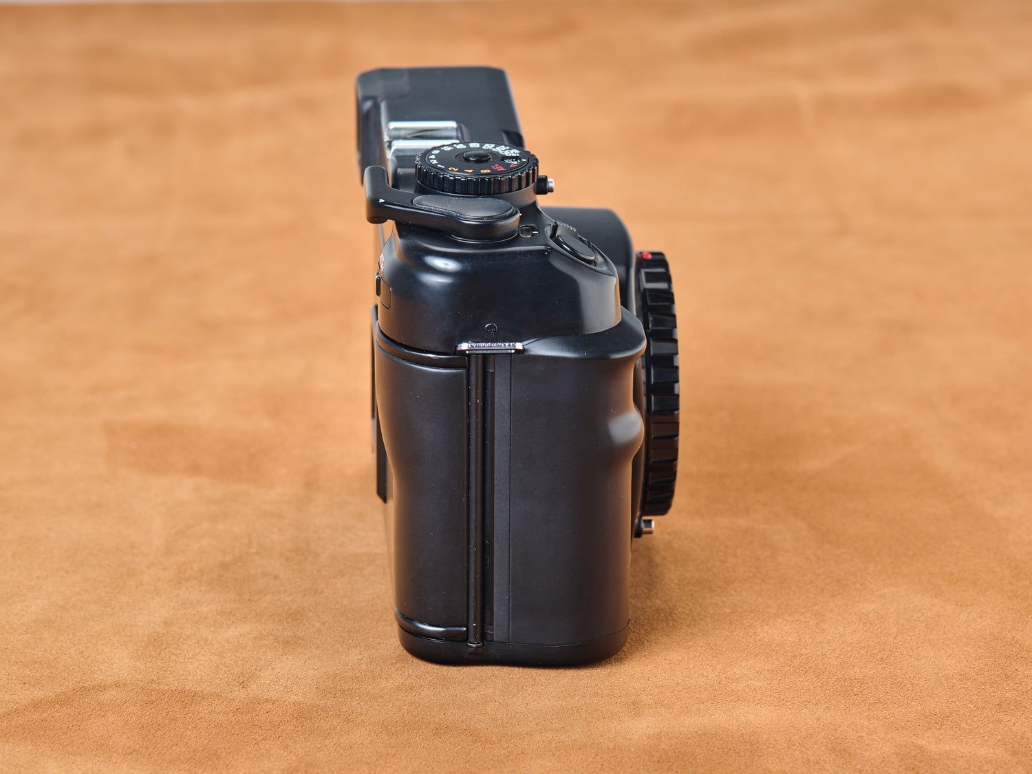 Black Mamiya 7i II medium format rangefinder camera. Side view of grip.