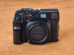 Mamiya 7ii rangefinder black camera on a brown background